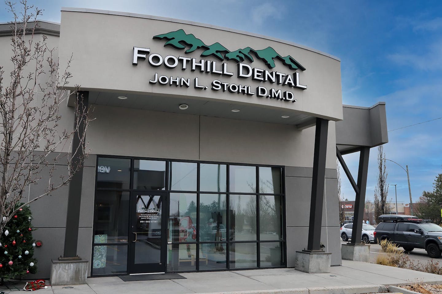 Foothill Dental storefront exterior with signage, glass entrance doors, and parking lot visible.
