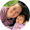 Woman and child smiling together in close-up portrait for dental practice website.